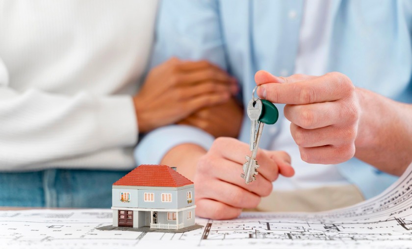 Couple holding keys about to rent